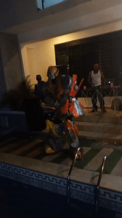 Transformer costume spotted at nighttime pool party in Nigeria