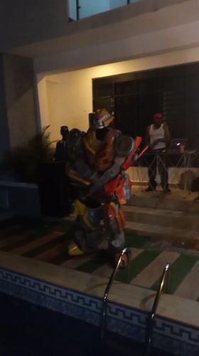 Transformer costume spotted at nighttime pool party in Nigeria