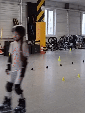 Children practice roller skating indoors in Novosibirsk sports facility