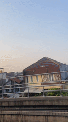 Elevated train-level view over East Jakarta's residential sprawl