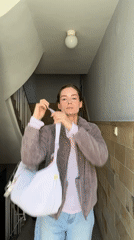 Woman takes selfie in Kiel building stairwell