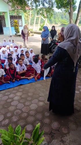 School children gather outdoors in Simpangjaya courtyard