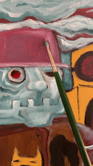 Artist paints stylized character with skull elements using green brush