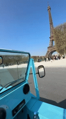 Tourist sightseeing captured at Eiffel Tower on sunny Paris day