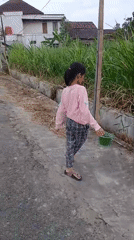 Drainage ditch cleanup on a residential street in Sitimulyo