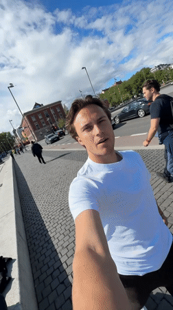 Young man takes selfie on Oslo waterfront walkway