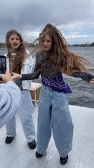 Girls filming on boat near Vyshenky Ukraine waterway