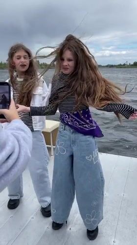 Girls filming on boat near Vyshenky Ukraine waterway