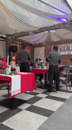 Rooftop restaurant celebration with heart balloons overlooks Kuala Lumpur skyline