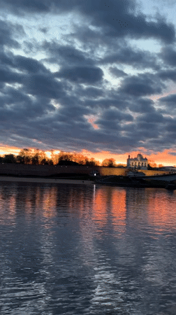 Orange sunset illuminates Volkhov River in Veliky Novgorod