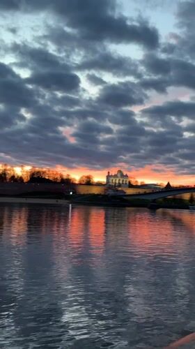 Orange sunset illuminates Volkhov River in Veliky Novgorod