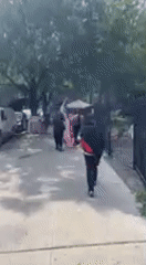 American flag carried through New York streets in late June
