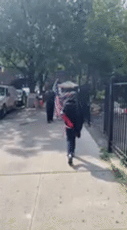 American flag carried through New York streets in late June