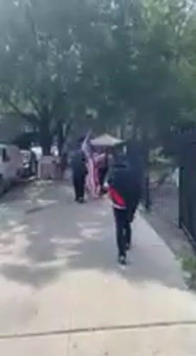 American flag carried through New York streets in late June