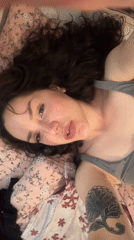 Woman photographed on floral bedding in Burgas apartment