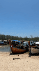 Longtail boats dock at Thai beach passenger area