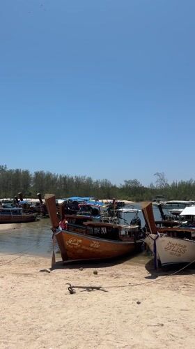 Longtail boats dock at Thai beach passenger area