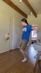 Young person dances in hallway, dog present in Chaikovsky
