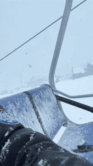 Skier rides lift in snowy conditions at Gudauri resort