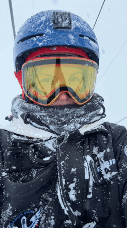 Skier rides lift in snowy conditions at Gudauri resort