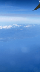 Aerial view captures calm Italian coastline from aircraft