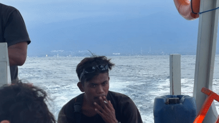 Boat passengers smoke, take selfies during Indonesian water crossing
