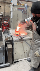 Worker operates industrial furnace in Saint-Rémy-lès-Chevreuse facility
