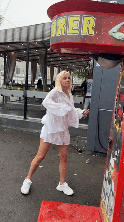 Punching bag arcade machine gets a hit in a white dress