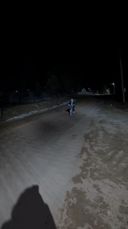 Child rides bicycle on snowy road in Dubovaya