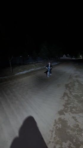 Child rides bicycle on snowy road in Dubovaya