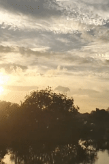 Sunset captured over waterways and villages in Lhokseumawe, Indonesia