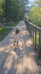 Child runs along park boardwalk in Saint Petersburg