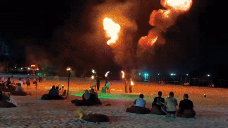 Fire dancers perform evening beach show in Langkawi Malaysia