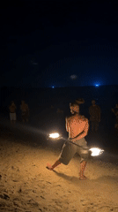 Fire spinner performs nighttime beach show in Thailand