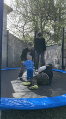 Family enjoys trampoline playtime in Russian backyard