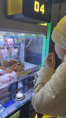 Girl plays crane machine at Russian arcade venue