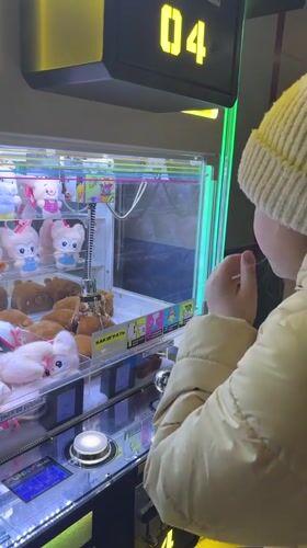 Girl plays crane machine at Russian arcade venue