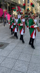 Historical marching band parades through city street Saturday morning