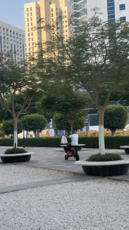 Street-level afternoon walkthrough of Dubai's modern business district