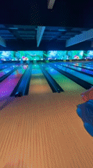 Friends bowl and take selfies at colorful bowling alley