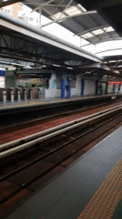 Commuter train arrives at a Kuala Lumpur station platform