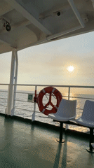 Ferry passengers document evening transit near Venezuelan coast