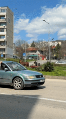 Horse-drawn cart carries three passengers through Varna streets