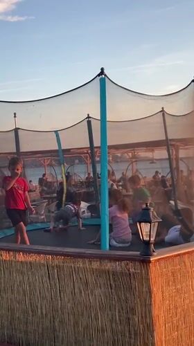Sunset dining and children's play at Bar Montenegro beachside restaurant