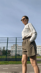 Woman films selfies near sports field in Klin, Russia
