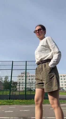 Woman films selfies near sports field in Klin, Russia