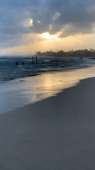 Sri Lankan beach communities enjoy sunset recreation amid dramatic skies