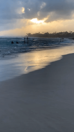 Sri Lankan beach communities enjoy sunset recreation amid dramatic skies