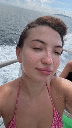 Ferry passengers take selfies during morning voyage near Pemenang