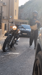 Person in leather jacket adjusts clothing in Montenegro